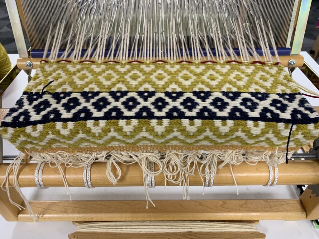 Close up of a boundweave on a table loom