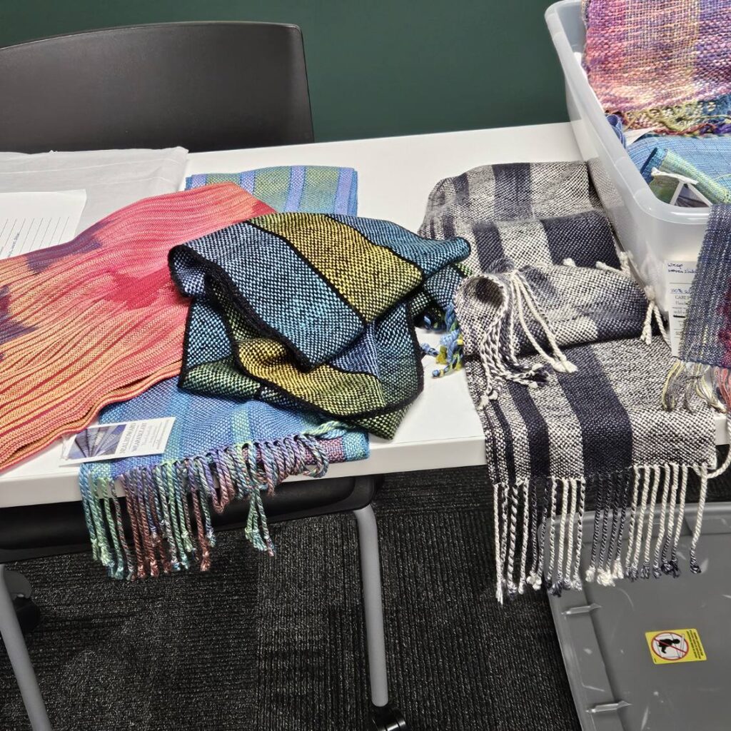 Display of Neal's handwoven silk scarves