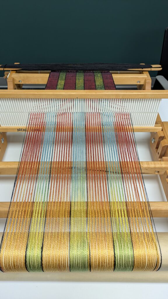 Silk warp on a table loom